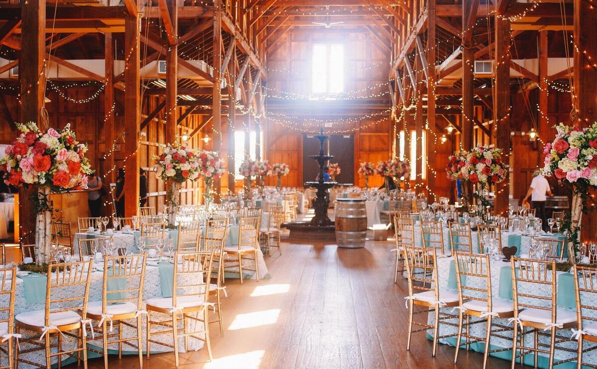 White daylight illuminates a wooden hangar prepared for a wedding