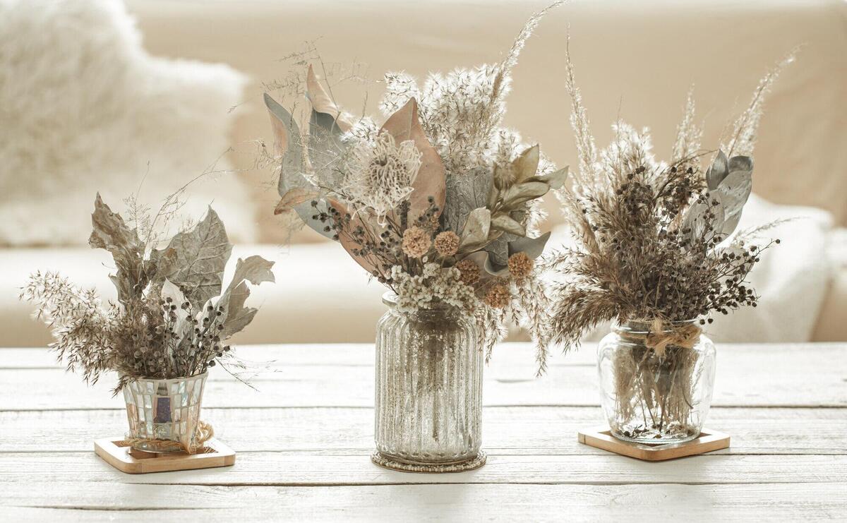 Background composition with many different dried flowers in vases
