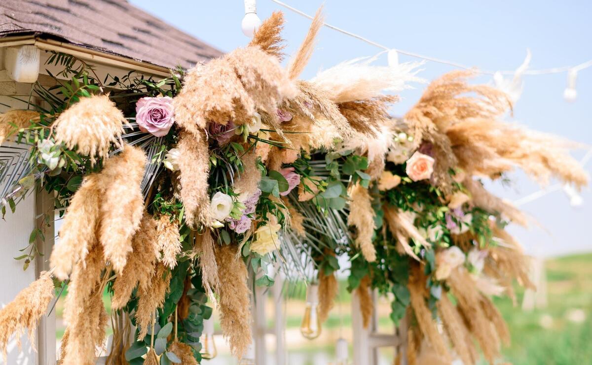 Natural decorations with flowers of wedding ceremony arch outdoors