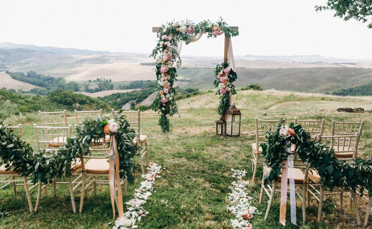 Italian wedding decoration. green eucalyptus, oranges and pink f
