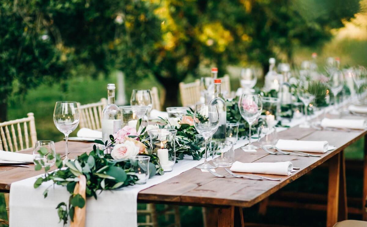 Floral garland of eucalyptus and pink flowers lies on the table