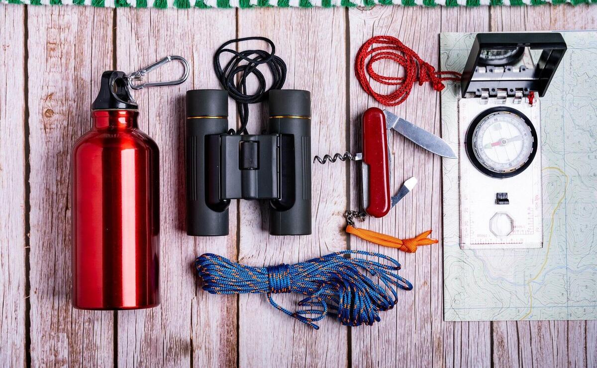 Flat lay of hiking equipment on the wooden surface