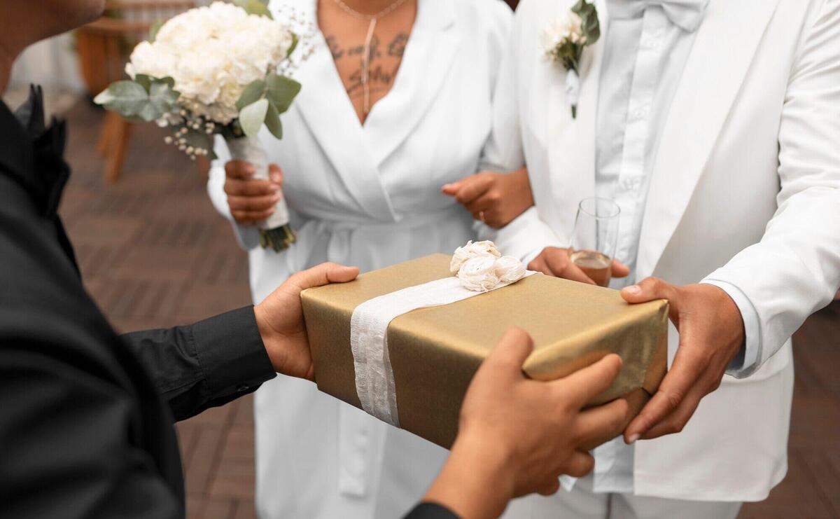 Lesbian couple accepting gifts from guests at their wedding