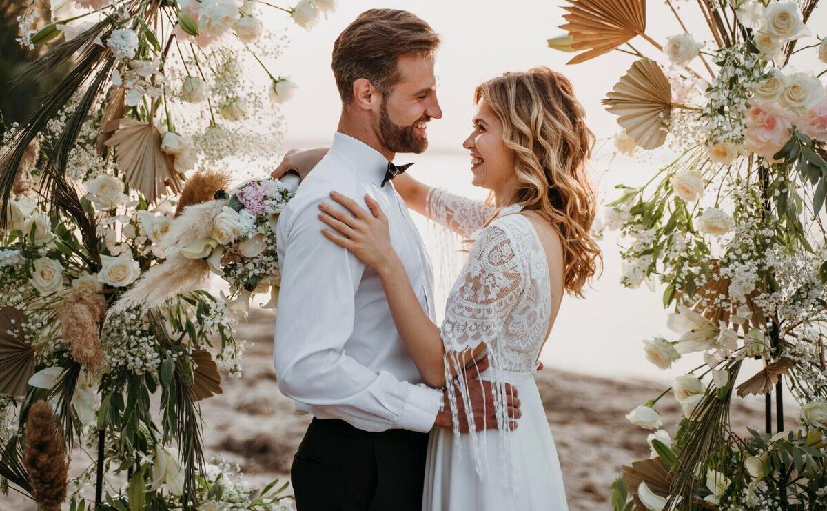 Bride and groom having their wedding at the beach