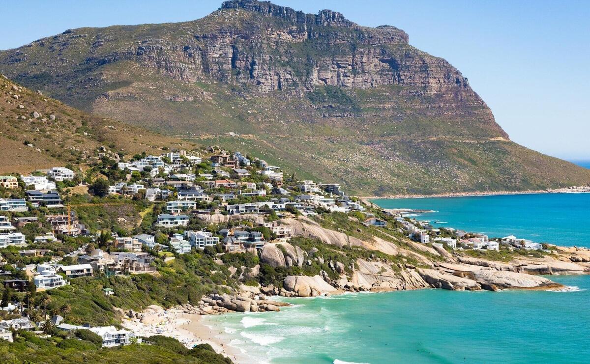 Beautiful shot of buildings on a hill at turquoise beach in Cape Town, South Africa