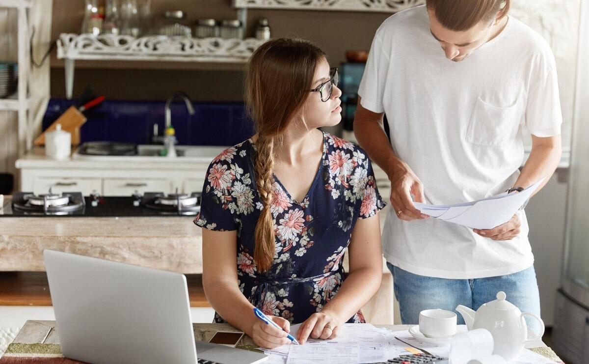 Couple managing budget together in kitchen