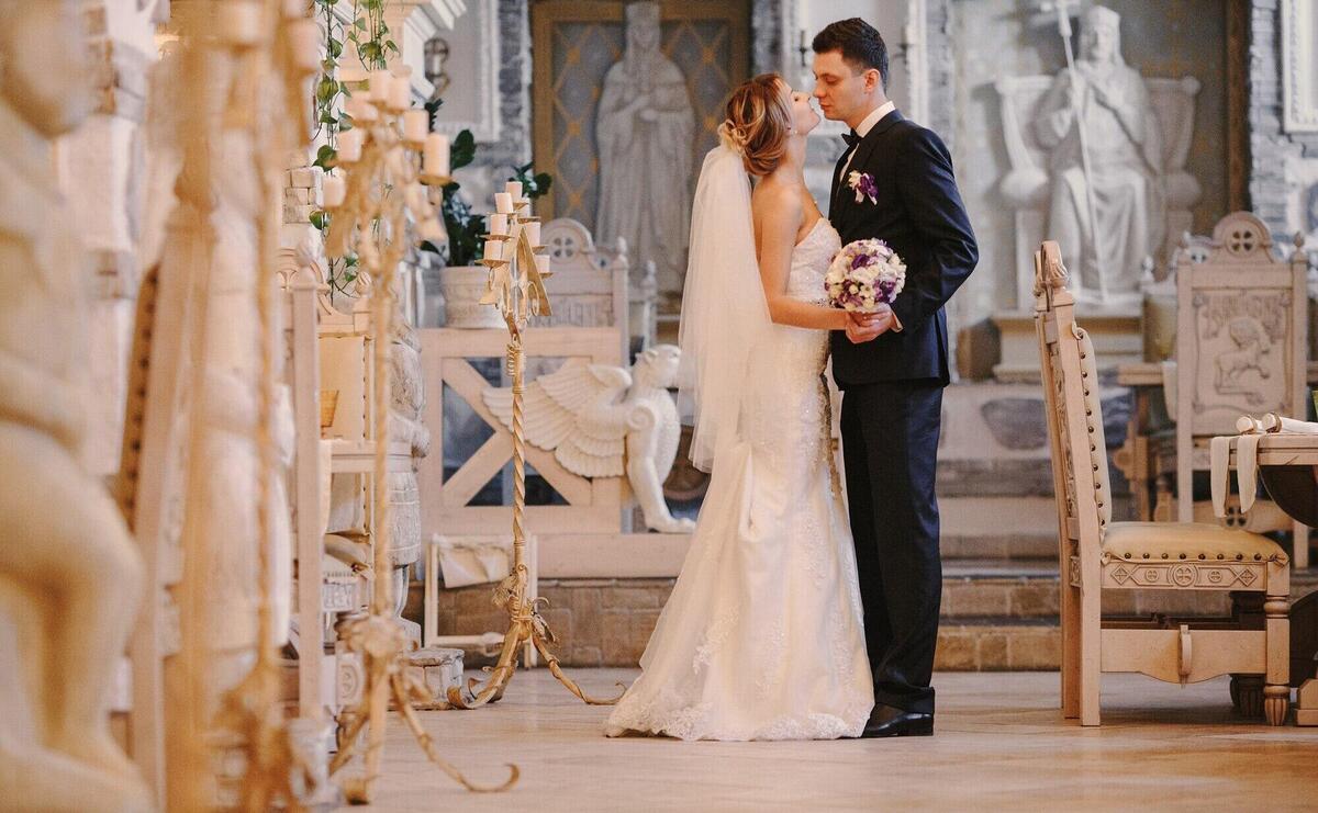 Newlyweds kissing in the church