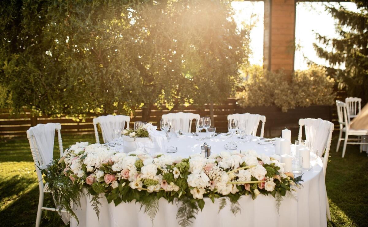 Elegant table setting at outdoor wedding reception.