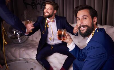 Men drinking whiskey at night club