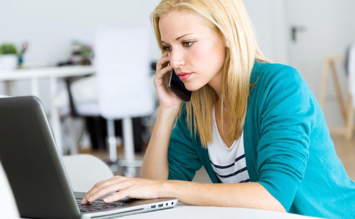 Pretty young woman working with laptop at home.