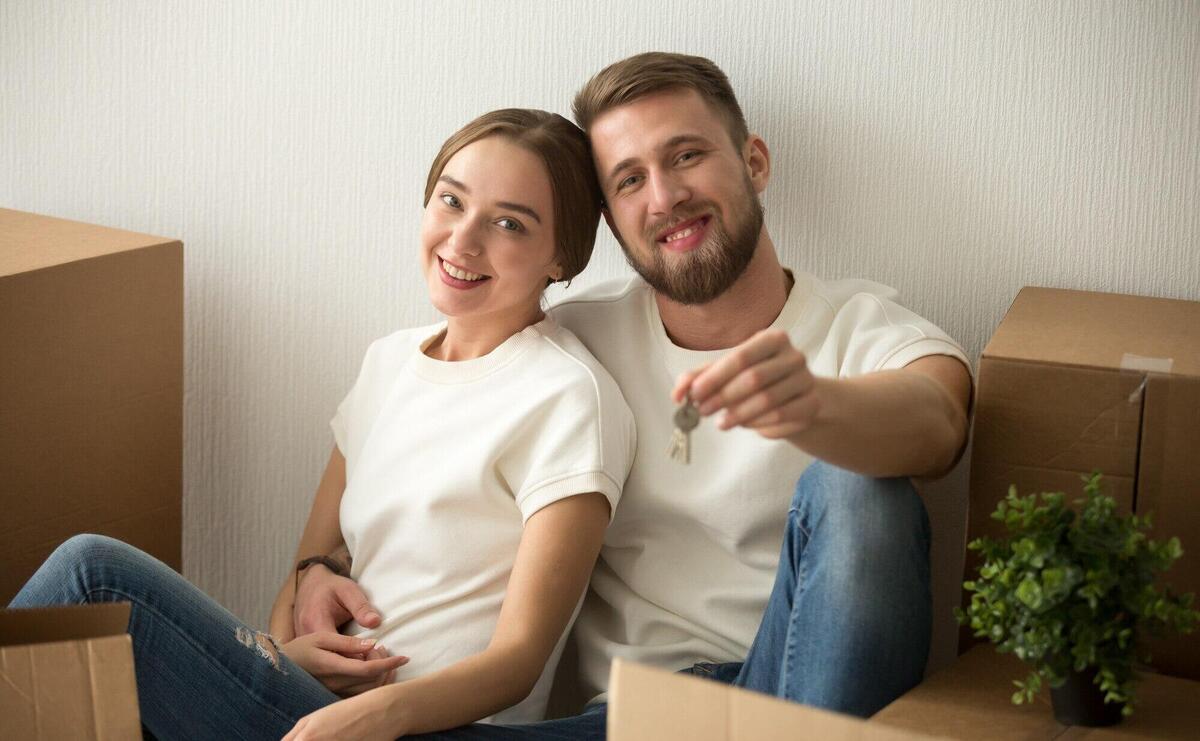 Portrait of couple holding keys excited to move in together