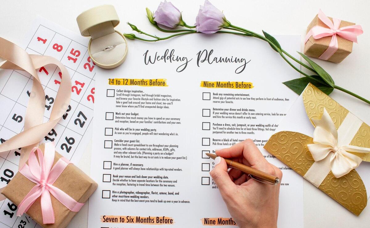 Feminine hands writing on wedding planner