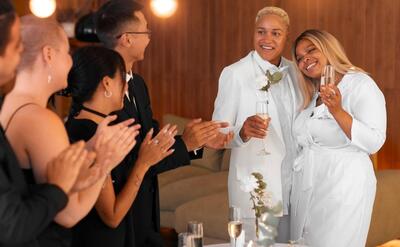 Lesbian couple with guests at their wedding