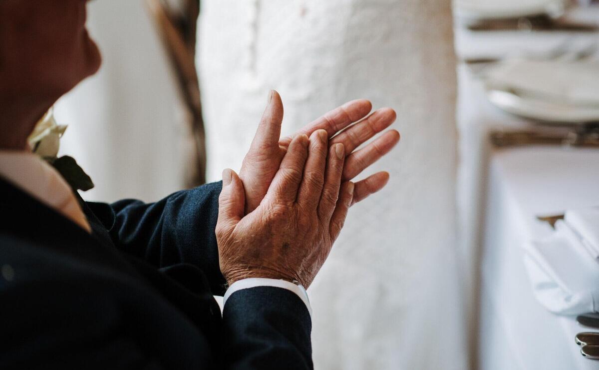 Closeup shot of an old male hands clapping
