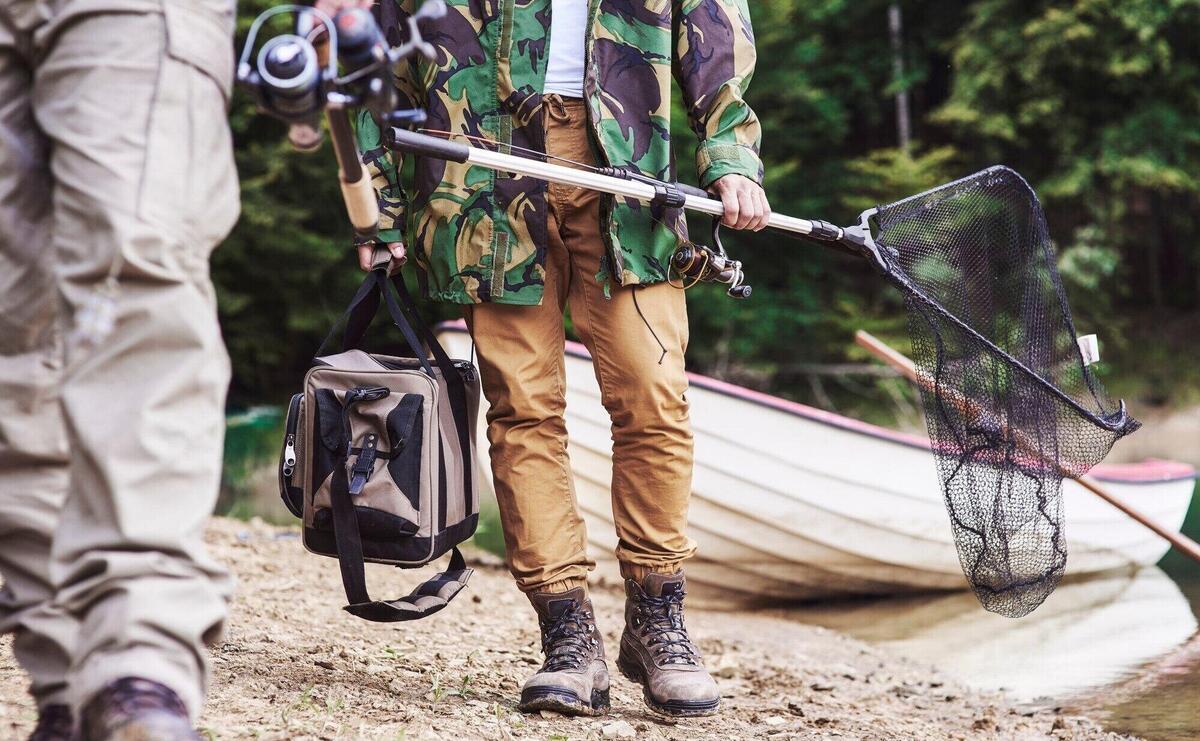 Men walking and carrying fishing tackle