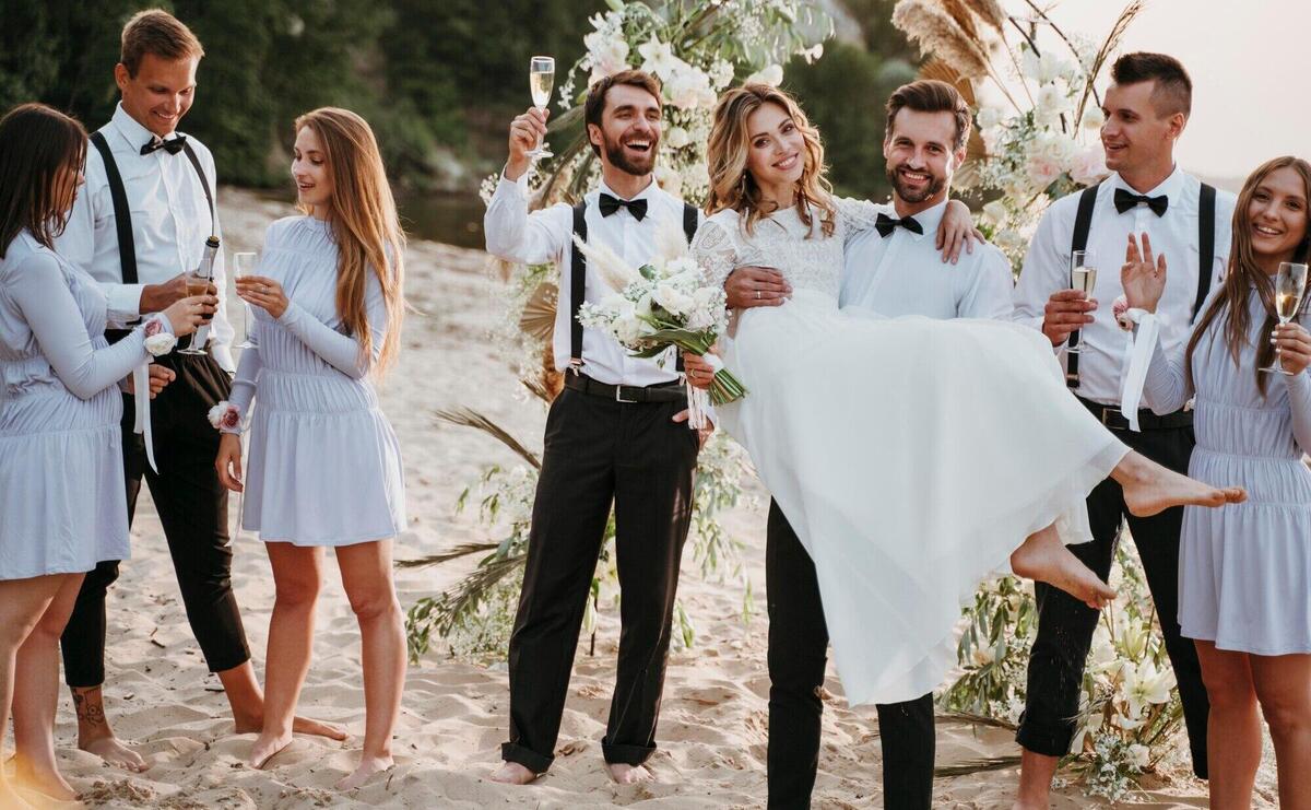 Bride and groom having their wedding with guests on a beach