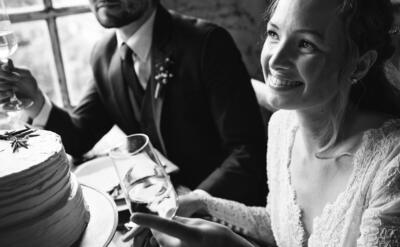 Bride and Groom Cling Wineglasses with Friends on Wedding Reception