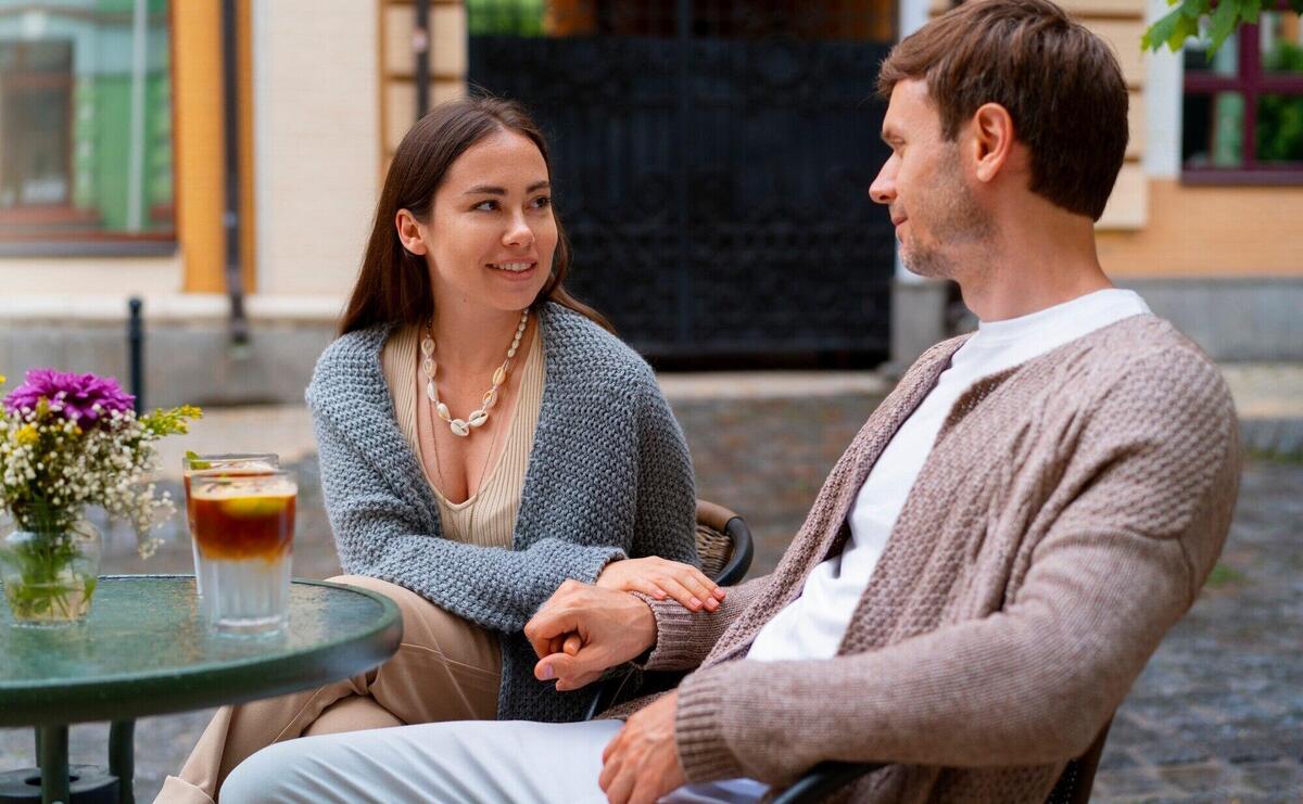 Happy couple taking drinks on a terrace